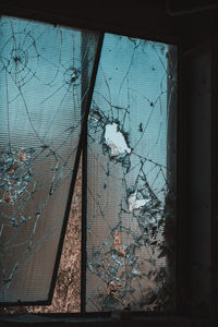 Broken glass window of abandoned building