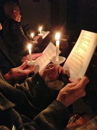 Close-up of hand holding candle