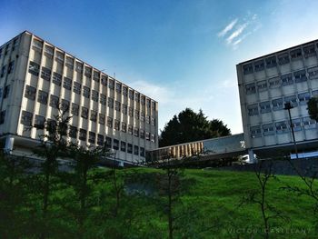 Low angle view of buildings against blue sky