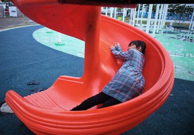 Midsection of boy playing in playground