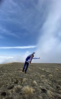 Full length of man standing on field against sky