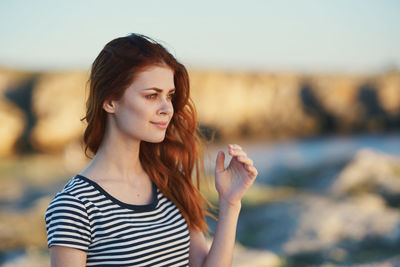 Portrait of young woman looking away