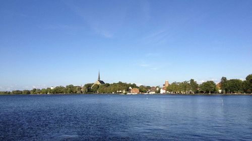 Scenic view of river against blue sky