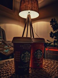 Close-up of illuminated lamp on table at home