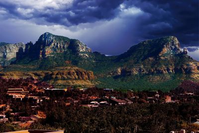 Panoramic view of buildings and mountains against sky