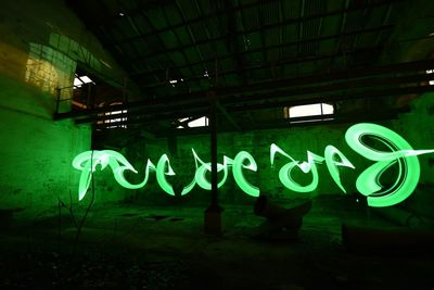 Graffiti on illuminated wall at night
