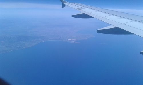 Cropped image of airplane flying over landscape