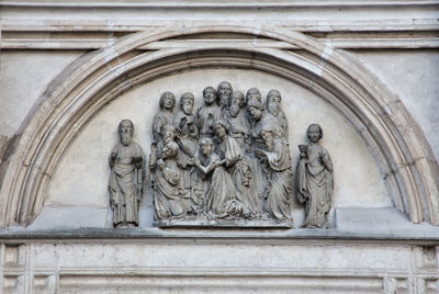 Low angle view of angel statue against building