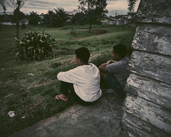 Rear view of people sitting outdoors