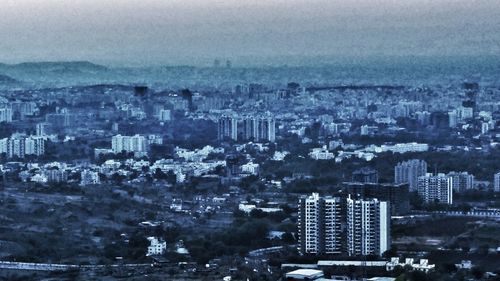 Aerial view of cityscape against sky