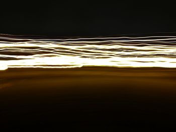 Close-up of illuminated lights against sky at sunset