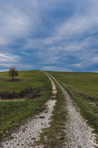 Empty road along countryside landscape