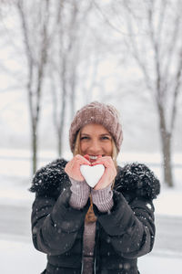 Portrait of woman with ice cream in winter