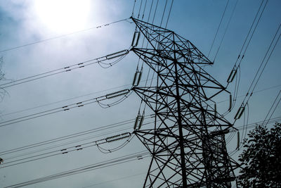 Low angle view of electricity pylon against sky