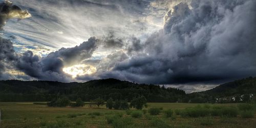 Scenic view of dramatic sky over land