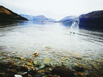 Scenic view of lake against sky during winter