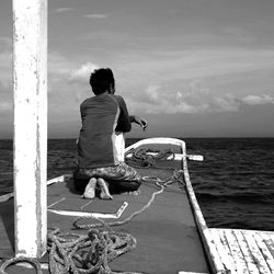 Full length of woman standing by sea