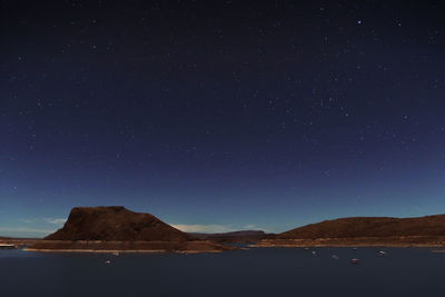 Scenic view of mountains against clear sky at night