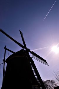 Low angle view of traditional windmill against sky