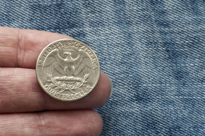 Close-up of a hand holding coin