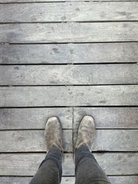 Low section of man standing on footpath