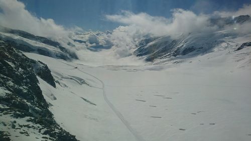 Scenic view of snow mountains against sky