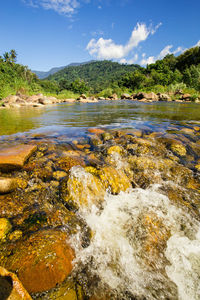 Scenic view of river and mountains against sky