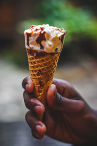 Cropped hand holding ice cream cone