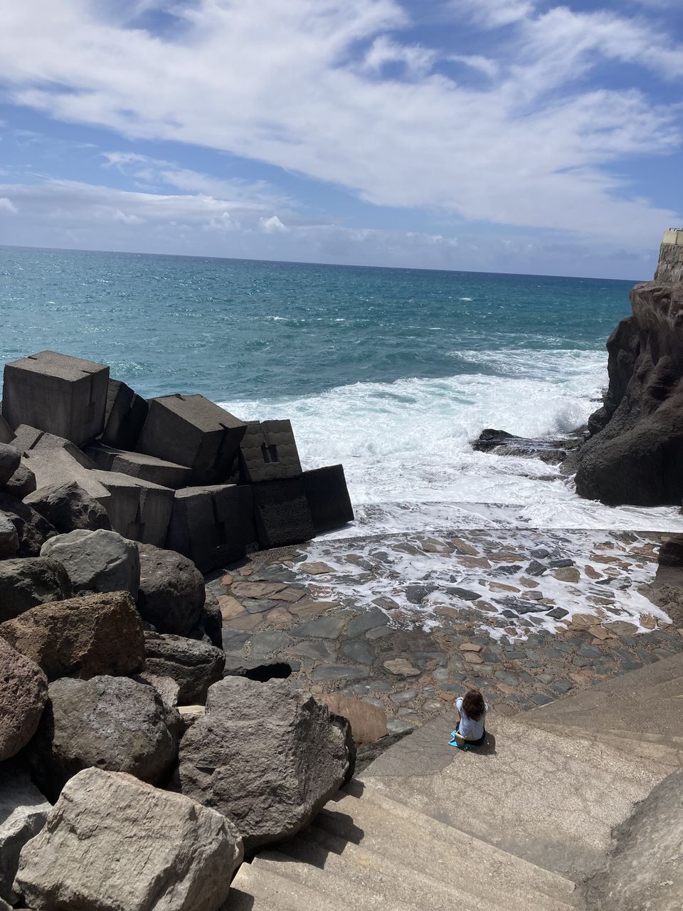 water, nature, sea, terrain, rock, day, blue, motion, sky, outdoors, beach, land, architecture, wave, no people, scenics - nature, beauty in nature, cloud, sunlight, screenshot, built structure, sports