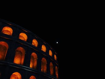 Low angle view of illuminated building against sky at night