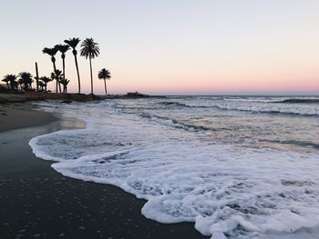 Scenic view of beach at sunset