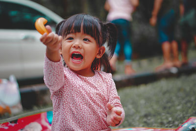 Portrait of cute girl holding camera