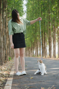 Asian woman happy during travel and play with her cat on spring season