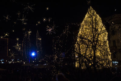 Illuminated christmas tree against sky at night