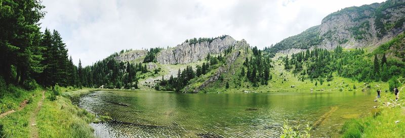 Panoramic view of lake and trees against sky