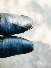 Close-up of human hand against sky