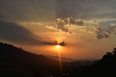 Scenic view of silhouette mountains against sky during sunset