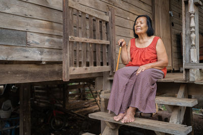 Portrait of woman sitting on bench