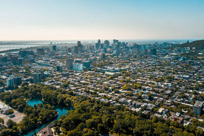 High angle view of buildings and sea against sky