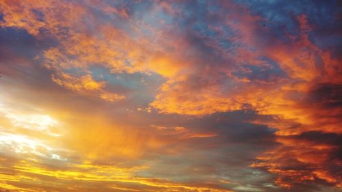 Low angle view of dramatic sky during sunset