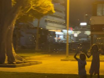 People on city street at night