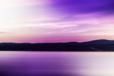 Scenic view of lake against romantic sky at sunset