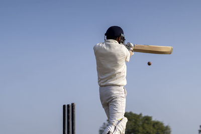 Low angle view of man standing against clear sky