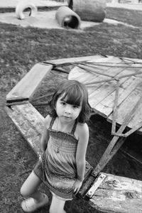 Portrait of smiling girl standing on wood