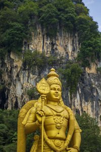 Low angle view of statue of against mountain