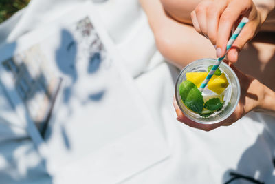 Midsection of woman having drink