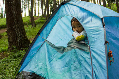 Portrait of boy in tent