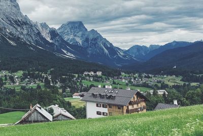 Houses by mountains against sky