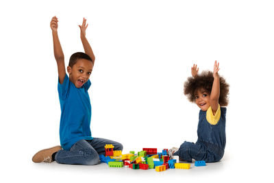 Children playing with toy against white background
