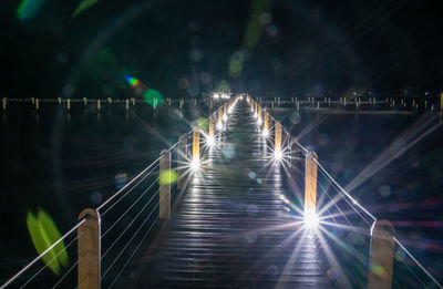 Illuminated footbridge at night